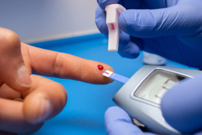 closeup shot doctor with rubber gloves taking blood test from patient